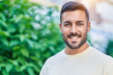 Canvas Print - Young hispanic man smiling confident standing at park