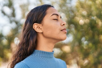 Sticker - Young african american woman smiling confident breathing at park