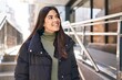 © Krakenimages.com - Young beautiful hispanic woman smiling confident looking to the side at street