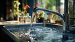 © STUDIAROZA - faucet with water flowing in the kitchen sink
