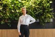 © Jacob Lund - Confident and mature business woman standing in a sustainable business office