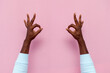 © Богдан Маліцький - african american male hands show ok sign on pink isolated background