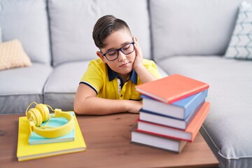 Sticker - Adorable hispanic boy student sitting on floor with boring expression at home