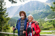 © Halfpoint - Portrait of active senior couple hiking together in autumn mountains.