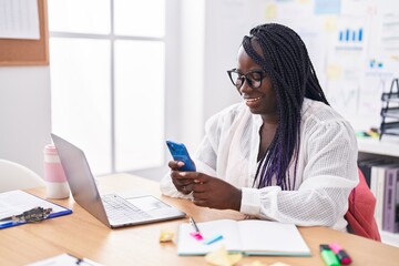 Sticker - African american woman business worker using laptop and smartphone at office