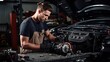 © Meow Creations - Handsome young mechanic working in auto repair shop, looking at the engine