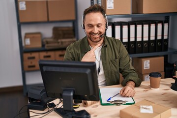 Poster - Middle age caucasian man working at small business ecommerce wearing headset smiling happy pointing with hand and finger