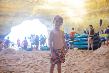 Children, enjoying Benagil, Portugal. Benagil Cave inside Algar de Benagil, famous sea cave in Algarve coast, Lagoa.