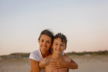 Poster - Happy children, boys, playing on the beach on sunset, kid cover in sand, smiling, laughing