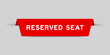 Red color inserted label with word reserved seat on gray background