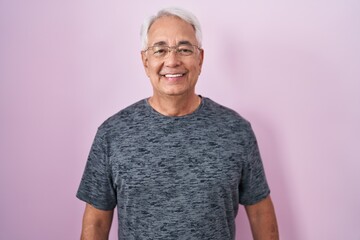 Poster - Middle age man with grey hair standing over pink background with a happy and cool smile on face. lucky person.