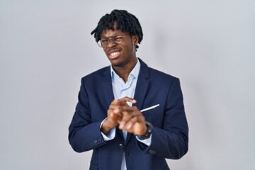 Poster - Young african man with dreadlocks wearing business jacket over white background disgusted expression, displeased and fearful doing disgust face because aversion reaction.