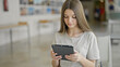 © Krakenimages.com - Young beautiful girl student using touchpad studying at library