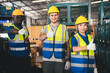 © DJ Creative Studio - Group of Diverse Warehouse and Factory Workers Working Together in Storehouse, Teamwork of Male and Female Warehouse Workers Standing in Transport and Logistics Industry.