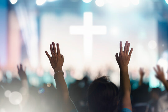 christian worship concert background. people group sing praise and pray to god in church on easter d