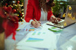 © Alliance - Business owner woman in green office with Christmas tree working