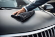 © Nishan - Exquisite car care: Precision in motion with microfiber cloth. High-quality stock photo