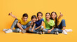 © Prostock-studio - Happy multiethnic kids sitting on floor, showing thumb ups