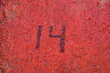 Numéro 14. Inscription peinte en noire sur mur ocre.