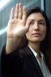 © primopiano - closeup shot of an unrecognisable businesswoman raising her hand in a stop gesture