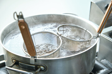 Buckwheat noodles cooking in big saucepan with hot water