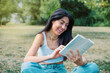 © boryanam - Woman reading a book in the summer park