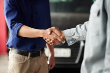Cropped Image Of Car Owner And Mechanic Shaking Hands, Greeting Each Other