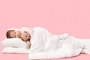 Wall Mural - Little girl with toy and soft blanket sleeping on pink background