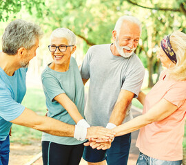 Wall Mural - outdoor senior fitness woman man lifestyle active sport exercise healthy fit retirement teamwork together holding hands