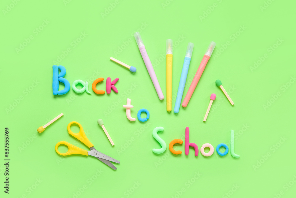 Text BACK TO SCHOOL and stationery on green background