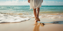 Wet Shoreline Sand With Barefoot Prints. Closeup Back View Photograph Woman Legs Walking Barefoot Along A Beautiful Beach. 