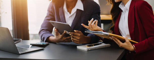 Asian professional successful female businesswoman secretary employee showing information strategy data via laptop notebook computer to male businessman manager in formal business suit in living room.