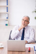 © Elnur - Old male employee working in the office