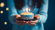 Partial view of woman holding birthday cake
