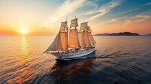 Big Sailing Ship At Sunset Sailing Through The Sea With A Blue And Orange Sky On The Background. Large Sailing Yacht Sailing On Bright Sunny Day With Clear Calm Water. Sail Vessel In Transparent Water