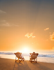 Poster - Young couple sunbathing on beach chair