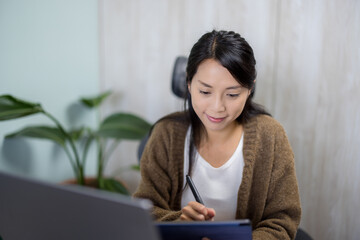 Poster - Woman work on laptop with tablet computer at home office