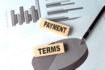Poster - PAYMENT TERMS text on wooden block on chart background