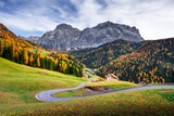 Fototapeta Natura - Winding road at the autumn Dolomite Alps. Amazing landscape with mountains on background at San Genesio village location, Province of Bolzano, South Tyrol, Italy