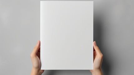 Poster - Female hands holding blank magazine gray background design template. Mockup image