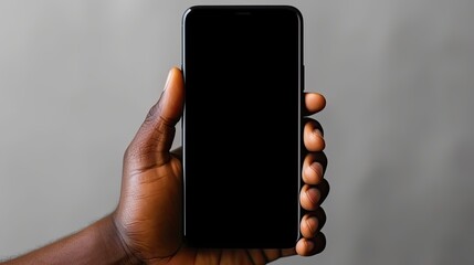 Wall Mural - African American man holding a new black smartphone with a blank screen Blank copy space for text. Mockup image