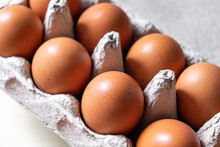 A Few Brown Eggs Among The Cells Of A Large Cardboard Bag, A Chicken Egg As A Valuable Nutritious Product, A Tray For Carrying And Storing Fragile Eggs. A Full Package Of Eggs, An Important Food Item