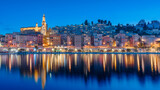 Fototapeta  - Cityscape of Menton at night, a historic town in the Provence-Alpes-Côte d'Azur region on the French Riviera