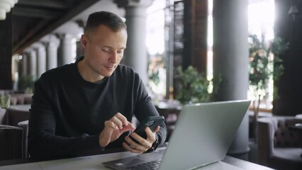Portrait Of Handsome Man With Smartphone And Laptop In Cafe, Internet Addiction Problem