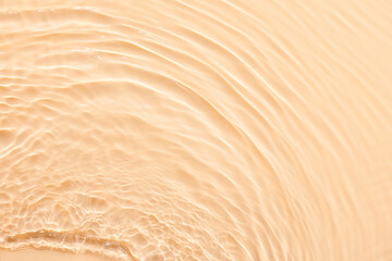 Wall Mural - Water beige surface abstract background. Waves and ripples texture of cosmetic aqua moisturizer with bubbles.