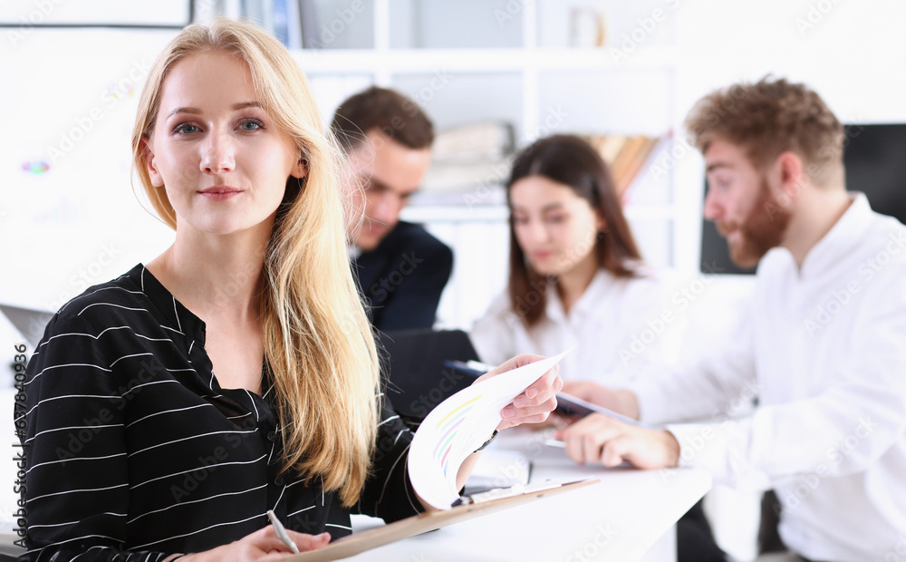 Beautiful smiling cheerful girl at workplace look in camera with ...