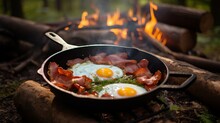 Camping Breakfast With Bacon And Eggs In A Cast Iron Skillet. Fried Eggs With Bacon In A Pan In The Forest.