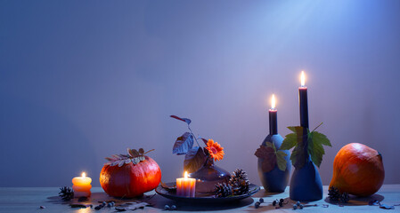 Wall Mural - autumn dark decor with candles on wooden shelf on background wall