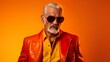 White bearded dreamer old man wear sunglass on red leather jacket & shirt with an yellow & orange gradient background.