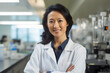 © Stock'd  - portrait of female asian pharmacist smiling wearing white coat in chemist shop